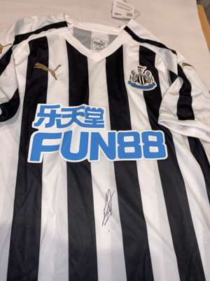 Miguel Almiron signed black and white Newcastle United replica home jersey 2018-19,
 Puma, short-sleeved with club crest and sponsor logo, signed in m