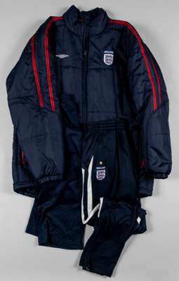 An official England coat with embroidered three lion badge, 
 Umbro, XL, the reverse lettered ENGLAND and a pair of England tracksuit bottoms with wit