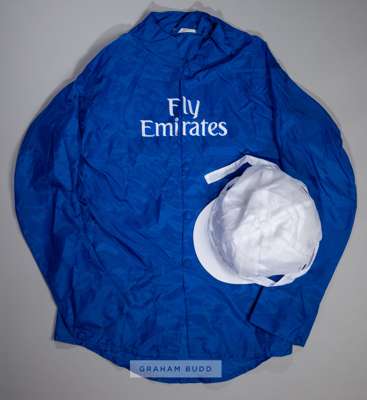 Godolphin royal blue silks,
 with white change-colour cap, embroidered FLY EMIRATES logo on the front of the silks