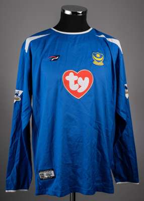 Lualua blue Portsmouth No.32 signed home jersey.
 the jersey is a long sleeved example with the Barclays Premier League badges on both. The front has 
