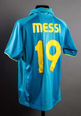 Lionel Messi signed Barcelona replica jersey, a turquoise No.19 away with 50 years at the Camp Nou inscription, signed to the reverse number in silver