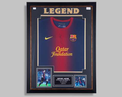 A Lionel Messi autographed garnet and blue Barcelona replica shirt display