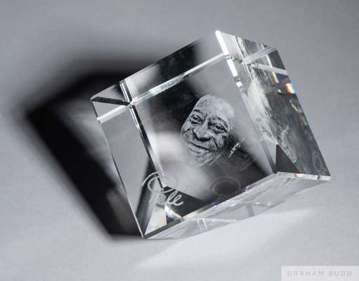 A crystal memento owned by Pelé featuring an internal laser-etched portrait of himself above the name Pelé.
 Includes a signed certificate of authenti