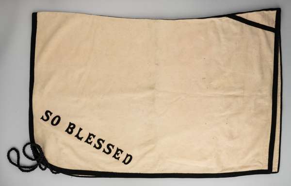 Blanket worn by the thoroughbred stallion 'So Blessed' at Lord Howard de Walden's Thornton Stud in Yorkshire,
 cream and black, bearing lettering in b