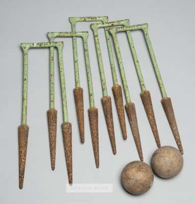 Five cast iron croquet hoops by Davidson, circa 1898,
 marked Pat no.26994; sold with two old croquet balls, (7)