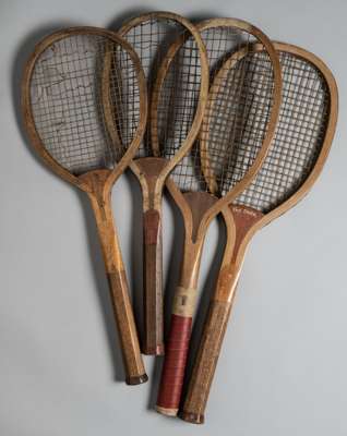 Four lawn tennis racquets,
 comprising T.H. Prosser & sons "The Daisy" convex wedge ridge handled racquet, circa 1900, stamped 21, F 5 12 on side of h