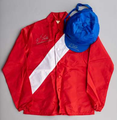 Cheveley Park Stud racing silks signed by Kieren Fallon,
 red jacket with white sash, royal blue cap, signed in silver marker pen

 Owners, in Flat an
