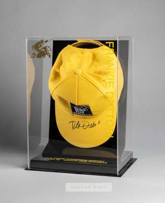 Frankie Dettori signed Dubai Duty Free Shergar Cup yellow cap, in presentation case,
 signed in black marker pen on the cap peak, within perspex prese