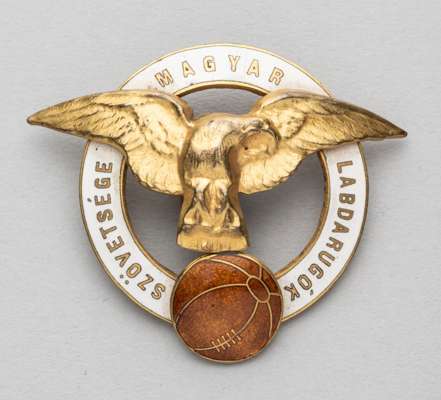 Hungarian Football Federation lapel badge, early 20th century,
 obverse with white enamelled ring with lettering in Hungarian, surrounding a golden ea