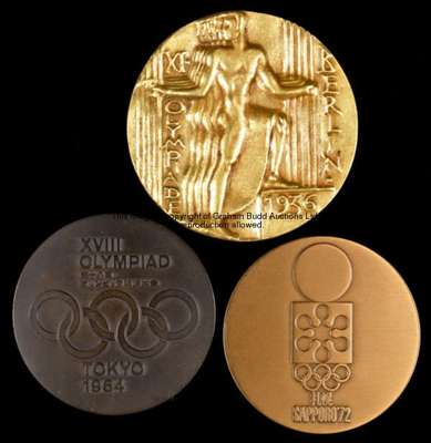 A Tokyo 1964 Olympic Games participation medal, in bronze, designed by Okamoto Taro