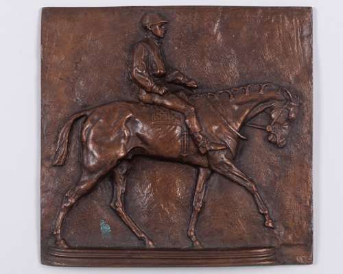 A 19th century bronze plaque with a racehorse & jockey in raised relief