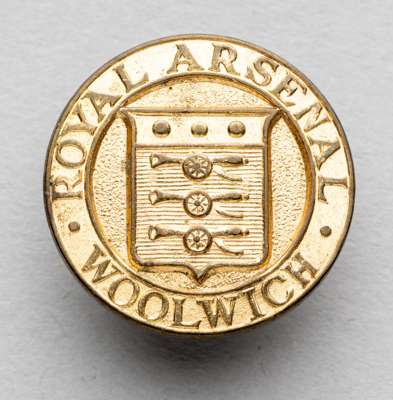 A badge of interest to Arsenal collectors being for the Royal Arsenal, Woolwich,
 in gilt-metal by T & S Ltd Birmingham, obverse with three cannon cre