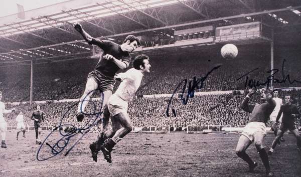 A b&w photographic print of the 1970 F.A. Cup final autographed by the Chelsea Cup winners Peter Osgood, Ron Harris & Tommy Baldwin, the 12 by 20in. i