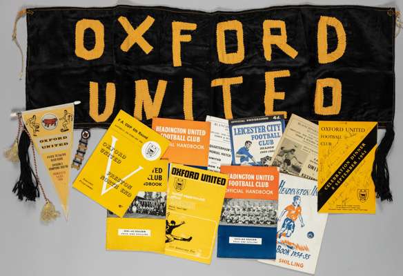 Collection of Headington United - Oxford United home & away programmes, handbooks, membership application forms and signed dinner menus, pennant, flag