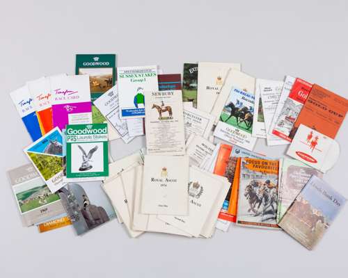 A collection of racecards and racecourse members' badges