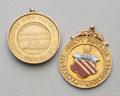 Two Manchester football medal's awarded to P Moon,
 comprising Manchester City F.C. medal to commemorative winning the Lancashire Cup 1920-21 awarded 