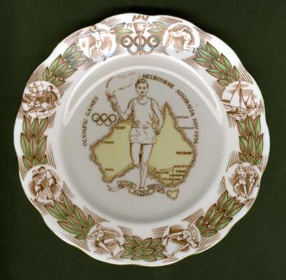 A souvenir bone china plate from the 1956 Melbourne Olympic Games, by Rostyn of England, central relay runner over map of Australia, the border featur