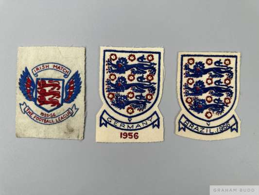 Two England shirt badges and one Football League shirt badge from the games against Brazil and Germany in 1956 and the Football League v Ireland in 19