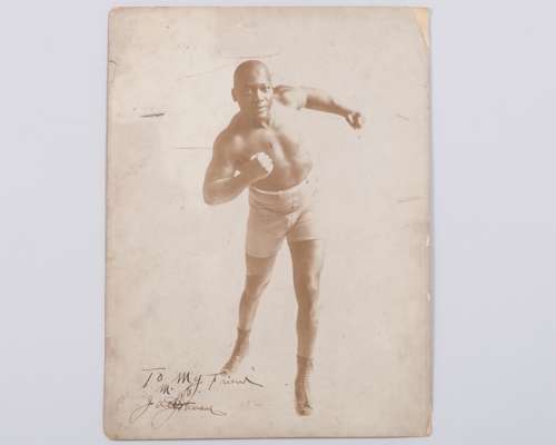 A sepia-toned photograph of boxer Jack Johnson