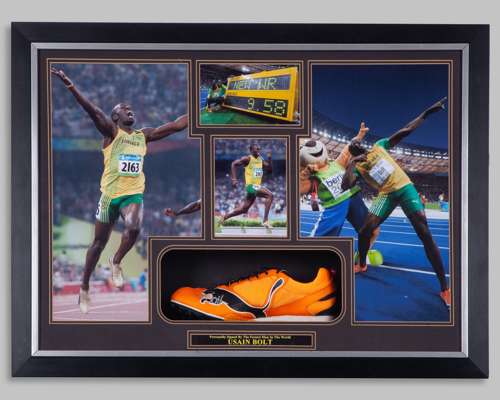 An orange Puma running spike autographed by Usain Bolt