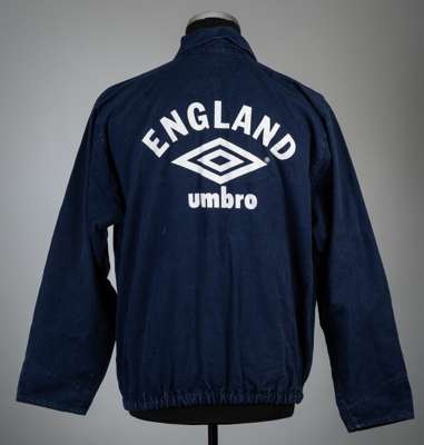Rare England navy training drill top,
 Umbro, long-sleeved with Umbro logo to front, reverse lettered ENGLAND with Umbro logo, elasticated waist, size