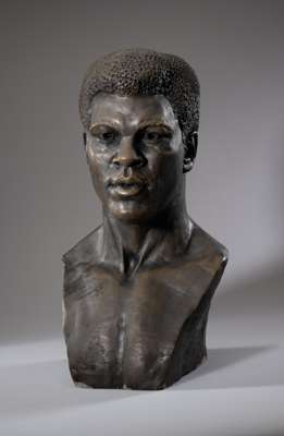 Bronzed resin profile bust of Muhammad Ali, bearing DRS inscribed artists medallion, 
 featuring a profile of Muhammad Ali, with inscribed medallion t