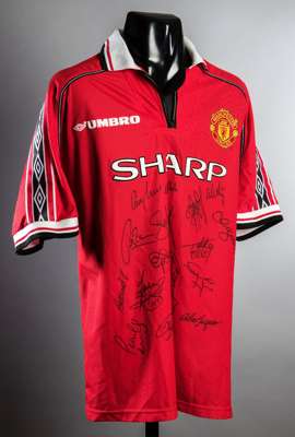 A multi-signed Manchester United 1999 Treble Winners jersey, 18 signatures in black marker pen including Ferguson, Sheringham, Solskjaer, Beckham, Sch