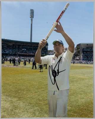 Excellent colour photographs signed to light part of image Warne walking off pitch at end of Australian victory stump aloft
