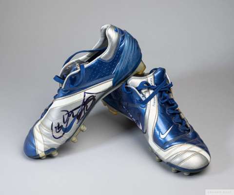 A pair of blue and silver size 8 Nike football boots, 
 moulded studs. Both signed in black marker pen, the player is unidentified. 

  The boots show