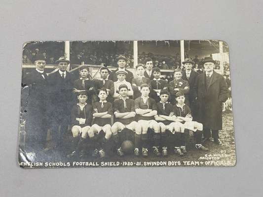 An English Schools Football Shield postcard, 1920-21, with legend, English Schools Football Shield 1920-21, Swindon Boys Team and Officials

 Edges wo