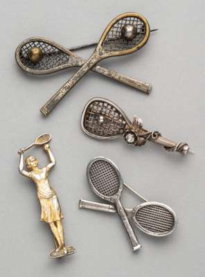 Four tennis brooches, 
 comprising three white metal brooches, two of crossed racquets with pin clasp on reverse, one of tennis racquet with tennis ba