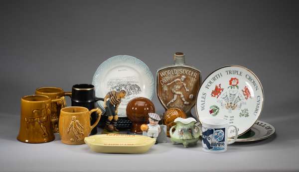 Quantity of football ceramics,
 including a Jim Beam Bourbon Whiskey bottle World Cup 1974, a pair of football shaped Money boxes, Euro '96 mug, four 