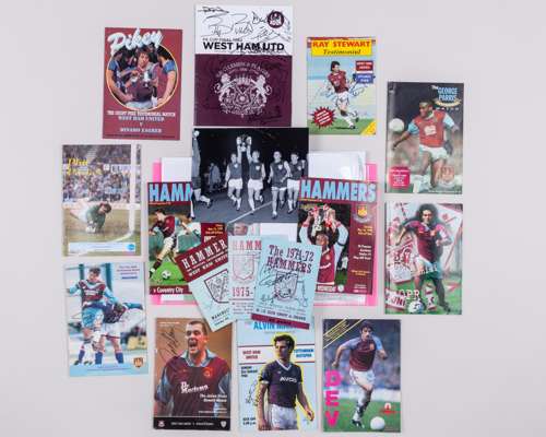 A folder of West Ham United autographed programmes and other materials