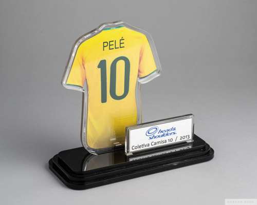 A trophy featuring a picture of Pelé's Brazil national football team jersey, 
 encased in acrylic, presented to Pelé by Head & Shoulders. Inscribed on