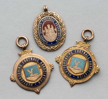 Two 9ct gold and enamel Hertfordshire FA football winners medals, 
 the first inscribed Herts. County Cup 1922-23, the other Herts. County League 1923