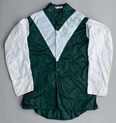 Wafic Said racing silks, 
 green jacket with white 'V' and sleeves, with makers label for Anne Cross, no size label

 Owner of Bosra Sham, Distant Rel