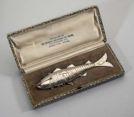 A 20th Century Indian silver reticulated model of a fish, 
 with pink inset eyes, in original fitted hinged case, the underside inscribed Presented to