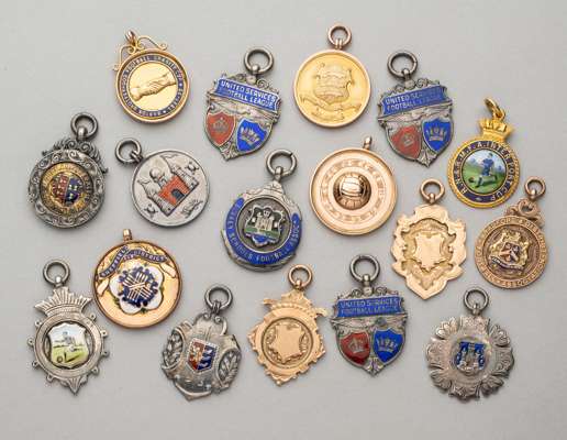 Collection of silver and gold football medals dating from 1911-12 to 1937-38,
 comprising Lancs & Chesam Football League silver and enamelled runner's