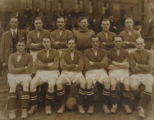 Rare b & w photograph of the Manchester United team, circa 1920s, 

featuring players and trainer in standing and seated pose, mounted on card with Al