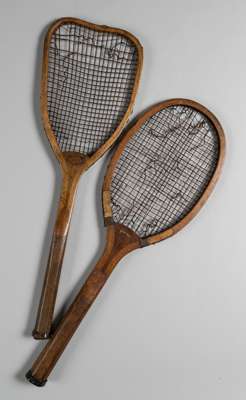 Two wooden framed tennis racquets,
 a flat top retailed by William Essex La Trobe of Bristol circa 1880s, the top pulled in by over tightening strings
