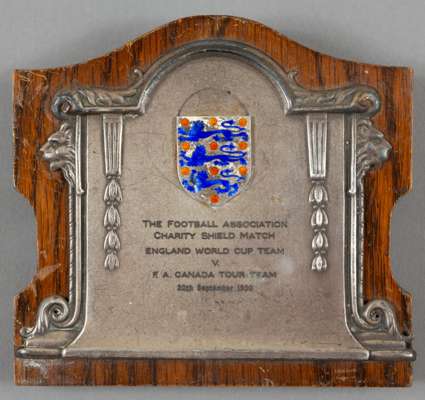 The 1950 F.A. Charity Shield winner's trophy awarded to Alf Ramsey,
 silvered metal & enamel on a wooden backboard with easel support, inscribed THE F