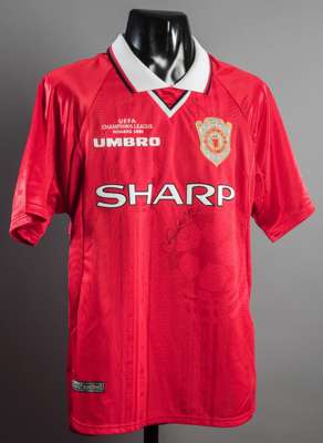 David Beckham signed replica Manchester United 1999 Champions League Final jersey, signed in black marker pen; sold with a colour photo of Beckham aft