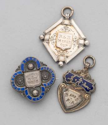 Two silver and enamel and a silver Berks & Bucks Football Association medals, 
 the obverse inscribed, B&B Minor Cup, the reverse inscribed 1899-1900,