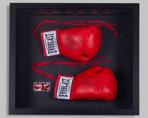 A pair of red Everlast boxing gloves autographed by Frank Bruno