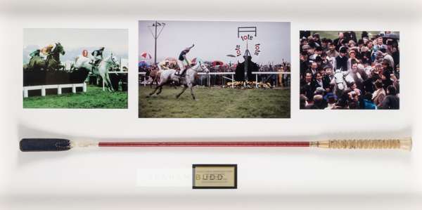 Simon Sherwood's whip used when riding Desert Orchid to glory at the Cheltenham Gold Cup on 16th March 1989,
 the red whip with white rubberized handl