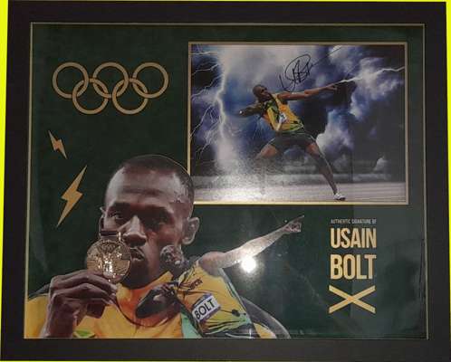 Olympics - Usain Bolt triple Olympic 100 and 200 meter gold medallist, the greatest sprinter of all time signed and framed 3-D display in the colours 
