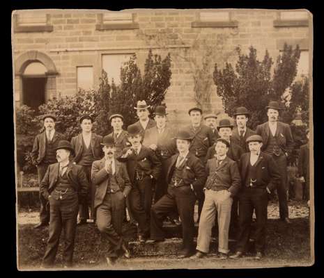 A period photograph of the Sheffield United 1899 F.A. Cup winning team, in civilian clothes and with virtually every player smoking a pipe, 10 by 11in