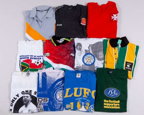 A collection of Leeds United polo shirts and commemorative t-shirts