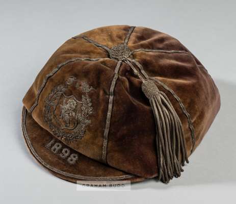 Scotland v Wales international cap dated 1898,
 velvet cap with silvered braiding and tassel, embroidered with S v W and lion rampant within a shield 