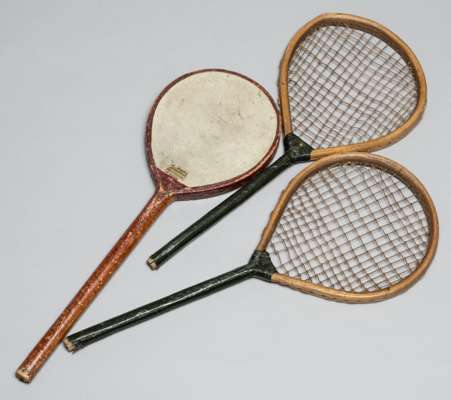 Pair of tennis play racquets, circa 1880,
 48 by 20cm; sold together with a rare battledore, warranted vellum number 4, 49 by 17 cm, which is strung o